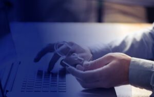 A person in front of a laptop holding a lock