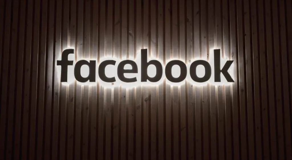 Facebook's desaturated logo on the wall